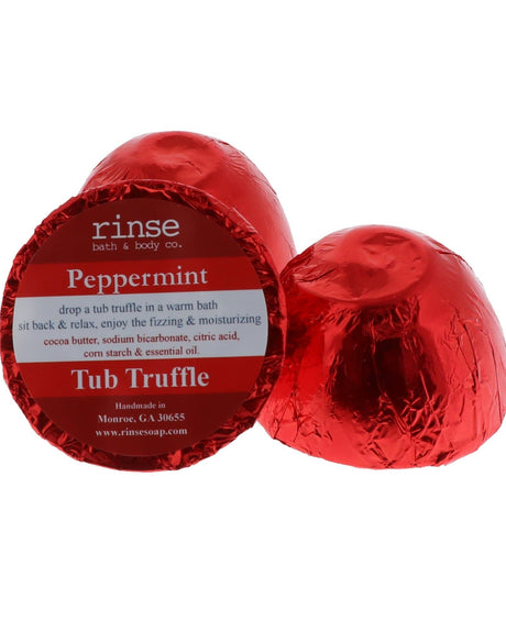 A red foil-wrapped Peppermint Tub Truffle beside a second one cut open to show the cocoa butter dome, on white — cool peppermint for a hot bath. Rinse Bath & Body Co.