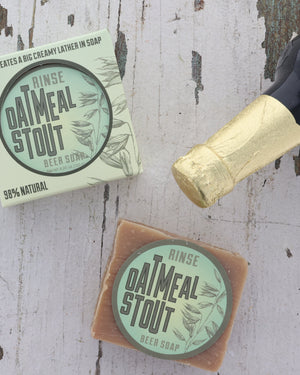 Oatmeal Stout bar soap styled warm and close — real stout in the batch, oats and warm caramel in a dense, creamy lather. Rinse Bath & Body Co.
