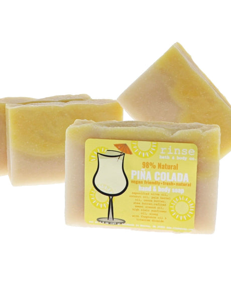Piña Colada soap with yellow cream tops stands front — hurricane glass art on clean bright white