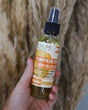 Pumpkin Spice Body Bliss oil on a warm neutral surface — lightweight autumn moisture that sinks in without a greasy finish. Rinse Bath & Body Co.