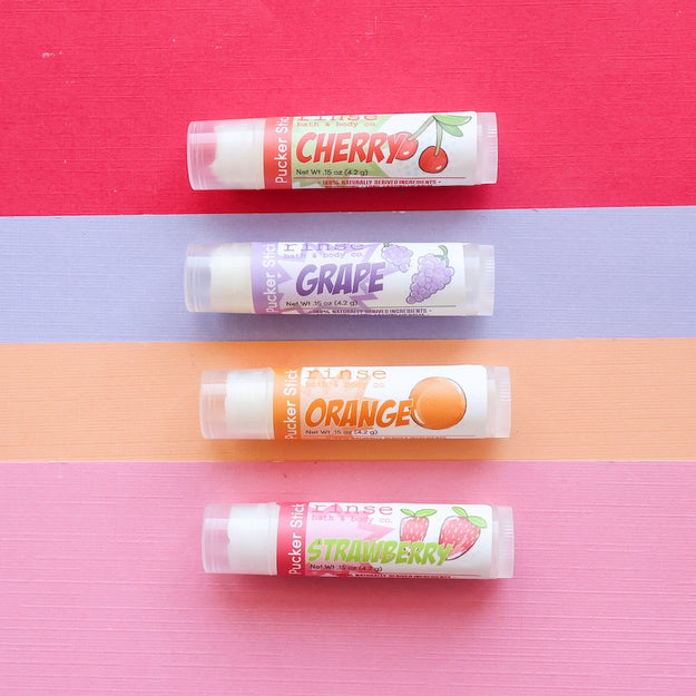 4 Rinse lip balms with different stripes of color behind each