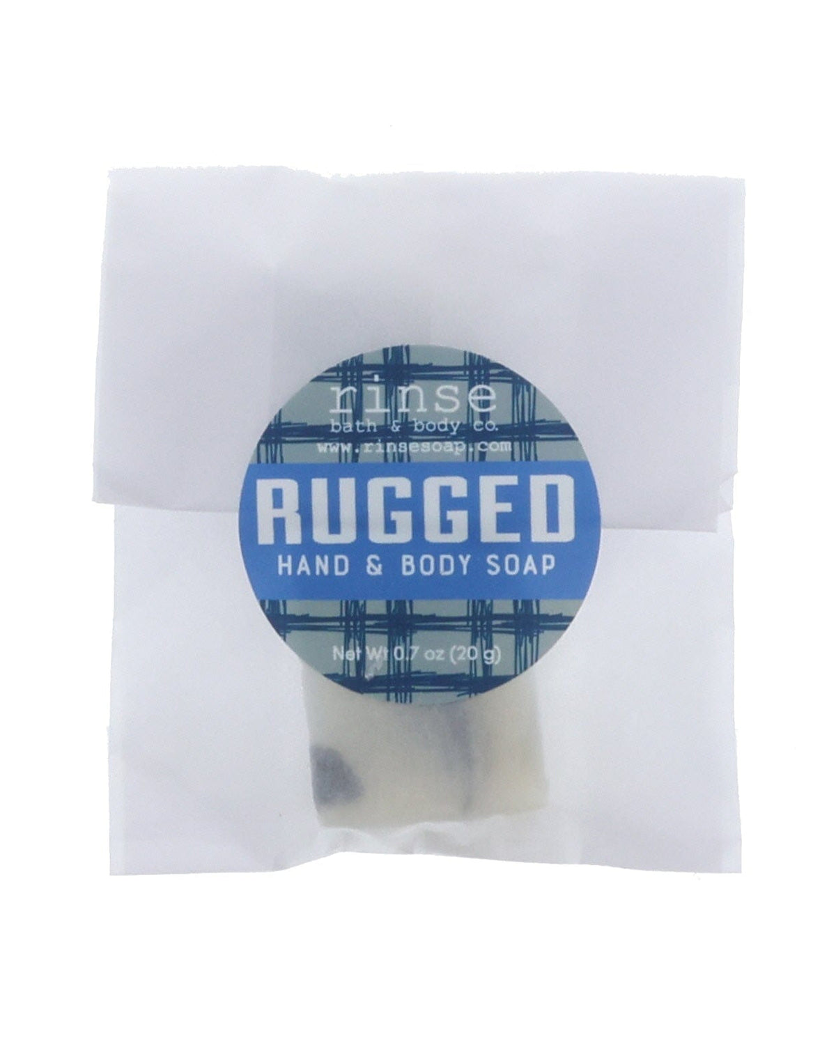 Rugged soap slice in translucent wrap — blue plaid circle sticker on clean bright white