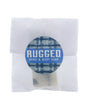 Rugged soap slice in translucent wrap — blue plaid circle sticker on clean bright white