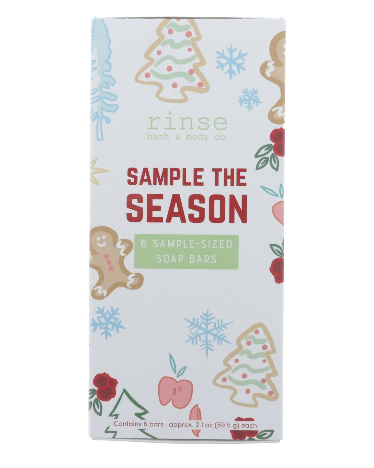 Sample the Season box standing on bright white — gingerbread, tree, snowflake, and berry illustrations with red SAMPLE THE SEASON lettering