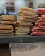 Rows of Rinse soap bars stacked on a wooden table