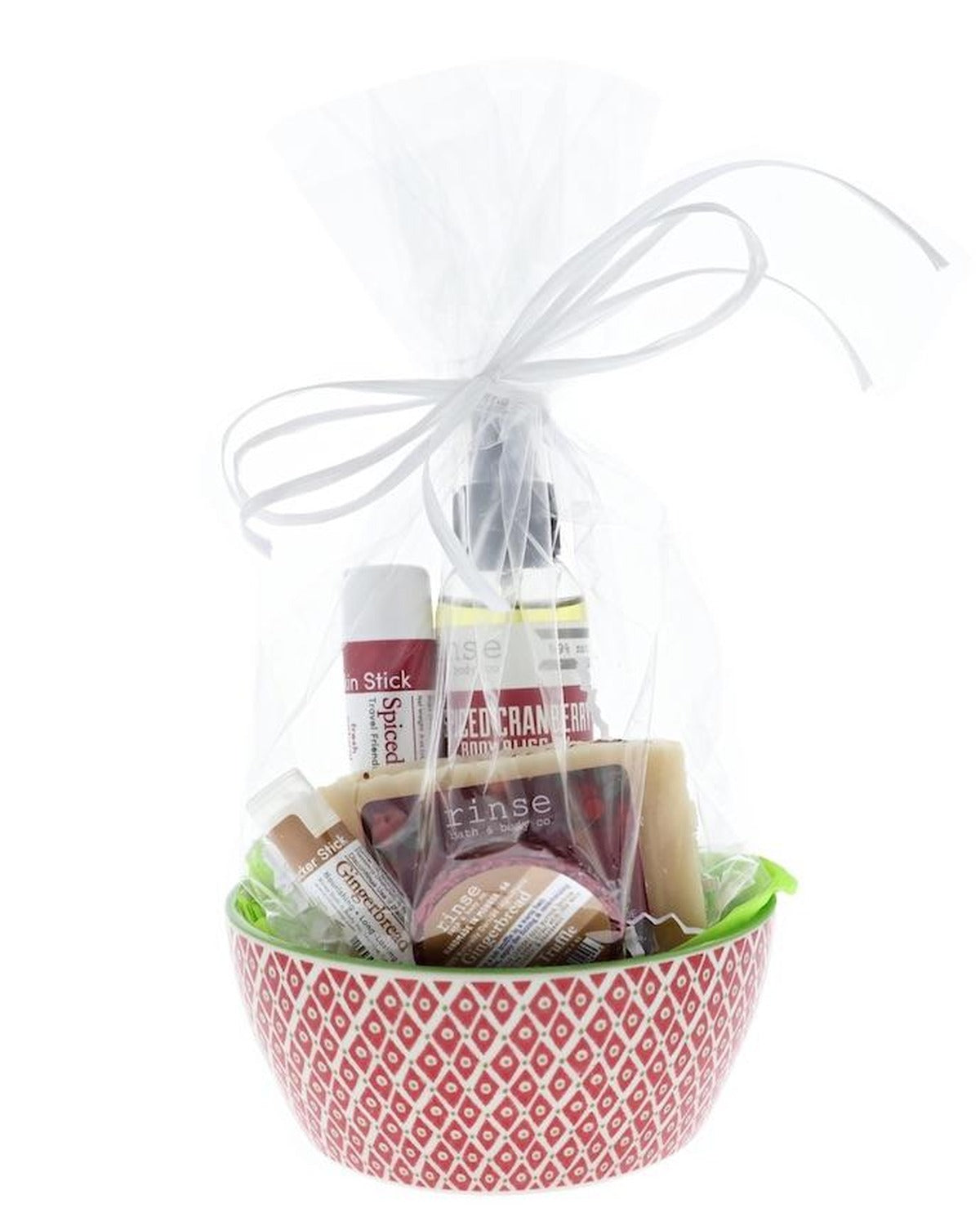 Spiced Cranberry holiday bowl gift set — red diamond ceramic bowl with green tissue, cello-wrapped soap, sticks, Body Bliss oil, and tub truffle tied with a white ribbon