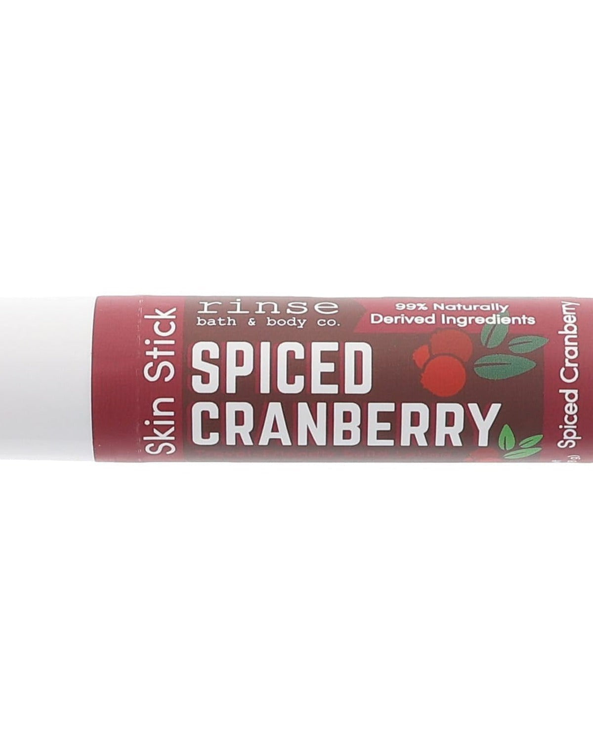 Spiced Cranberry Skin Stick lifestyle packshot — burgundy new label with cranberry graphic in studio light