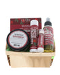 Spiced Cranberry travel set nestled in a wood berry till — green crinkle fill and burgundy labels on bright white