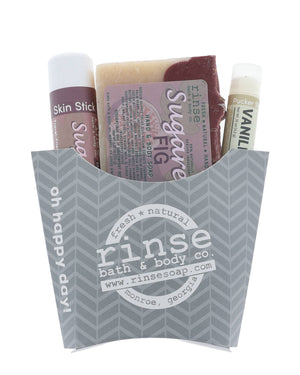 Gray herringbone fry carton holding Sugared Fig soap Skin Stick and Vanilla Pucker — plum accents on bright white