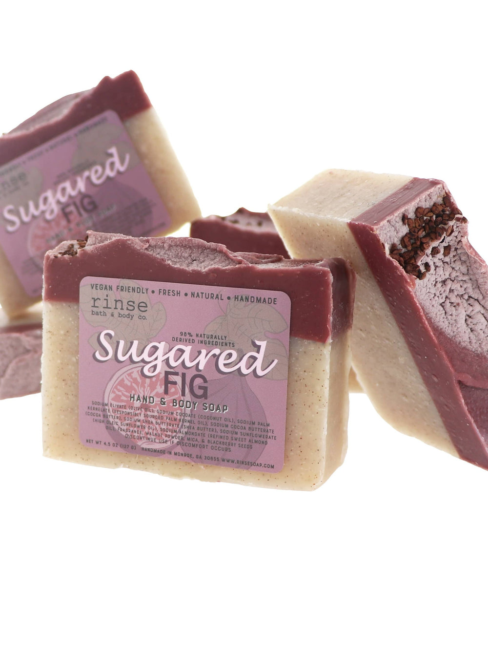 Sugared Fig soap bars stacked on bright white — cream base with plum top and seed-dusted swirl