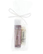 Sugared Fig Skin Stick and Vanilla Pucker Stick standing in a clear gift bag — plum and cream labels tied with a white bow
