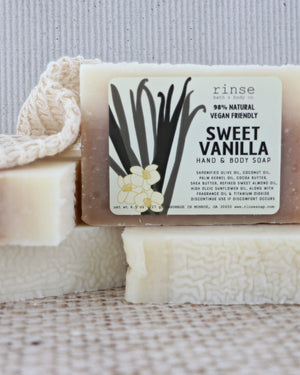 Sweet Vanilla bar soap styled on a warm neutral ground — soft, bakery-sweet vanilla for an everyday shower. Rinse Bath & Body Co.