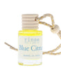 Blue Citrus car diffuser bottle standing on white — yellow oil, ribbed wood cap, and braided hang cord