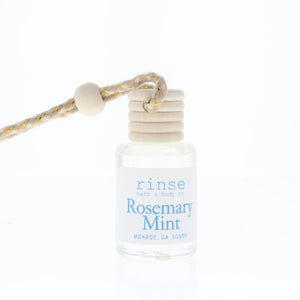 Bottle of 'rinse bath & body co' Rosemary Mint product with a rope on a white background