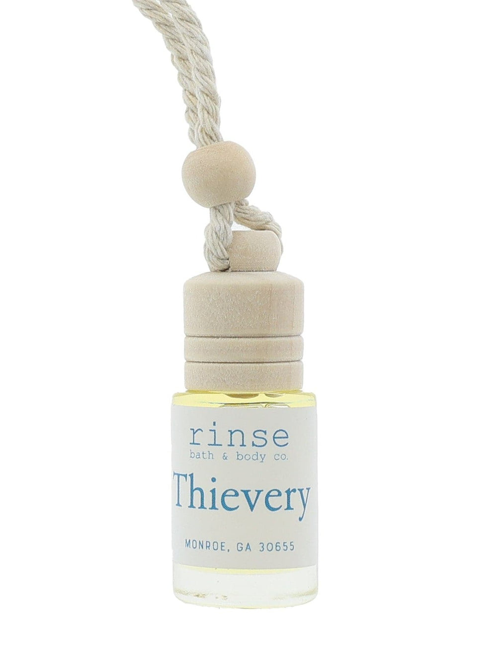 Thievery car diffuser hanging on bright white — clear glass wood cap and braided cotton cord in clean studio light