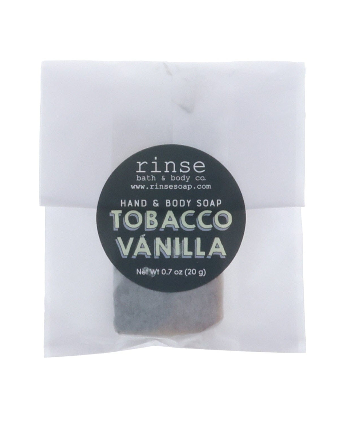 Tobacco Vanilla soap slice in frosted glassine — black circle sticker on clean bright white