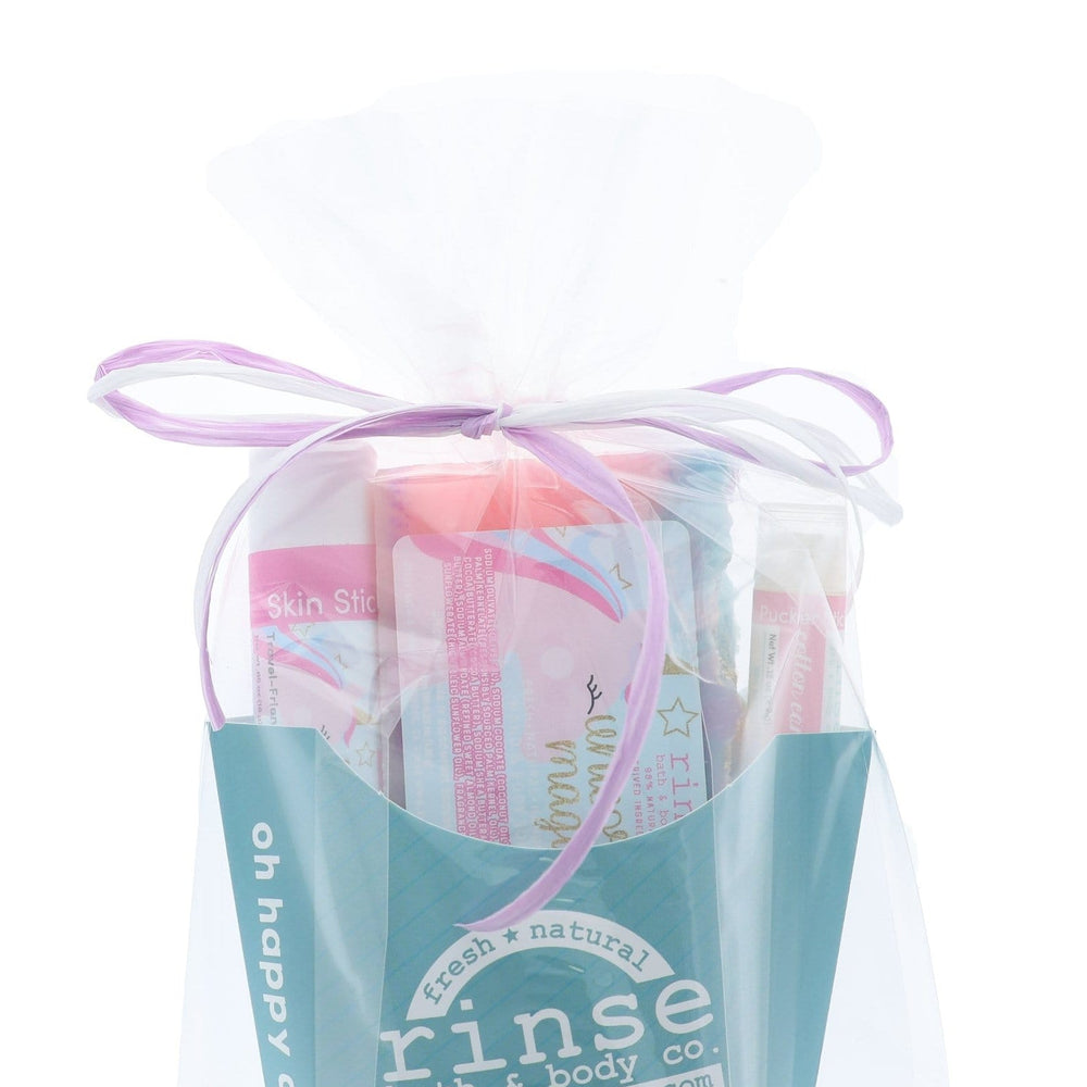 The Unicorn Magic gift set wrapped in cellophane and tied with a lilac ribbon bow — arrives gift-ready, no wrapping needed. Rinse Bath & Body Co.