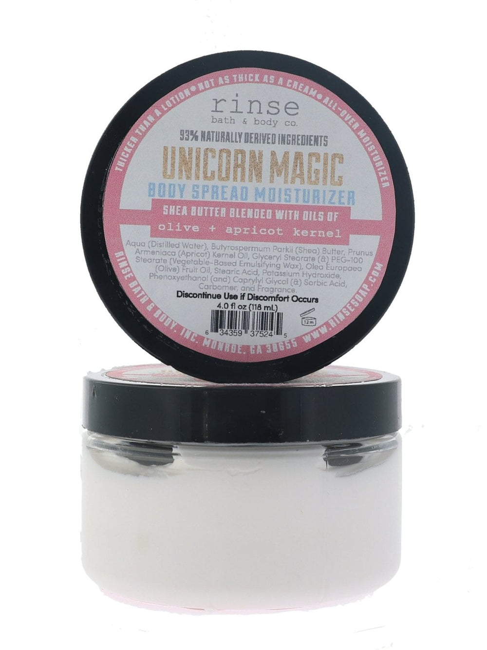 Unicorn Magic Body Spread jar with pink-label lid propped behind — thick white cream in bright studio light