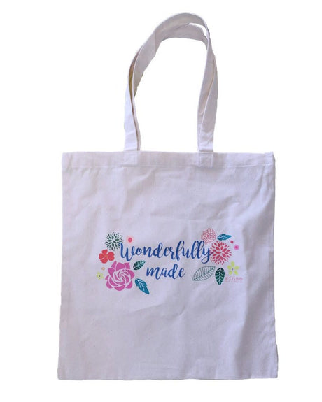 Wonderfully Made canvas tote bag flat lay — sturdy everyday carry accessory.