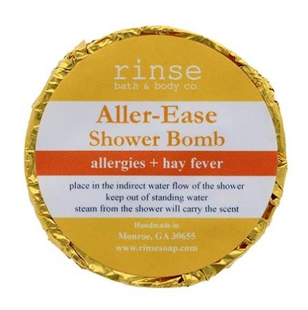 Gold-foil Aller-Ease Shower Bomb faces up — yellow-orange label crisp on clean bright white