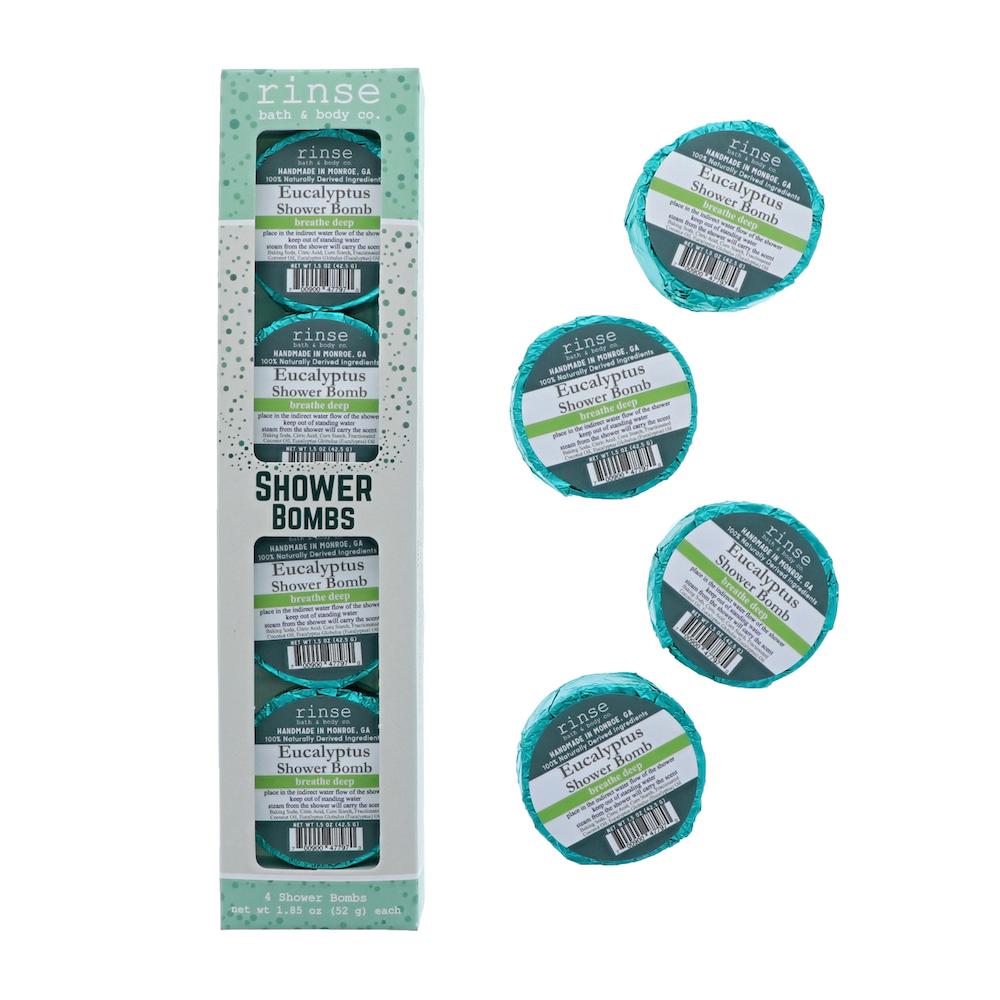 Eucalyptus 4-pack carton stands beside four teal-foil pucks — scattered on clean bright white