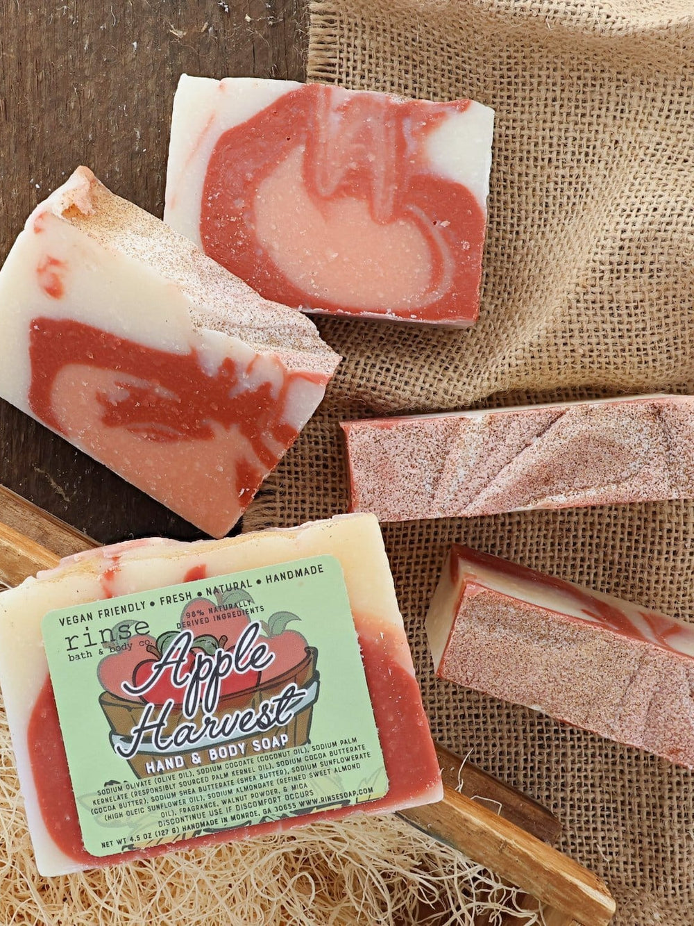 Apple Harvest bar soap from the side, showing its poured-batch edge and speckled apple-red top. Rinse Bath & Body Co.