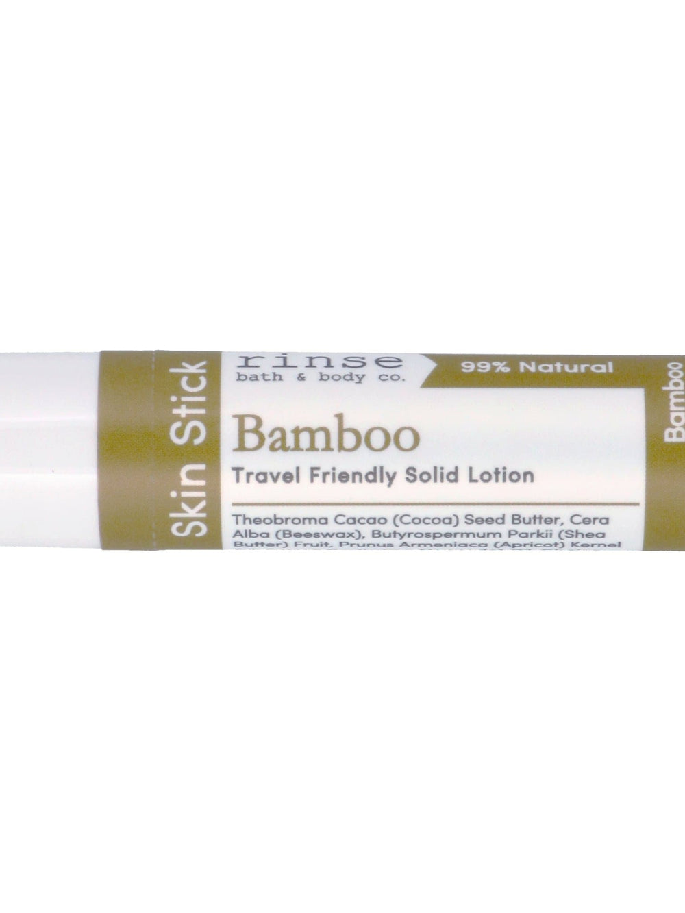 Bamboo Skin Stick lying on bright white — olive-green label and travel tube in clean studio light