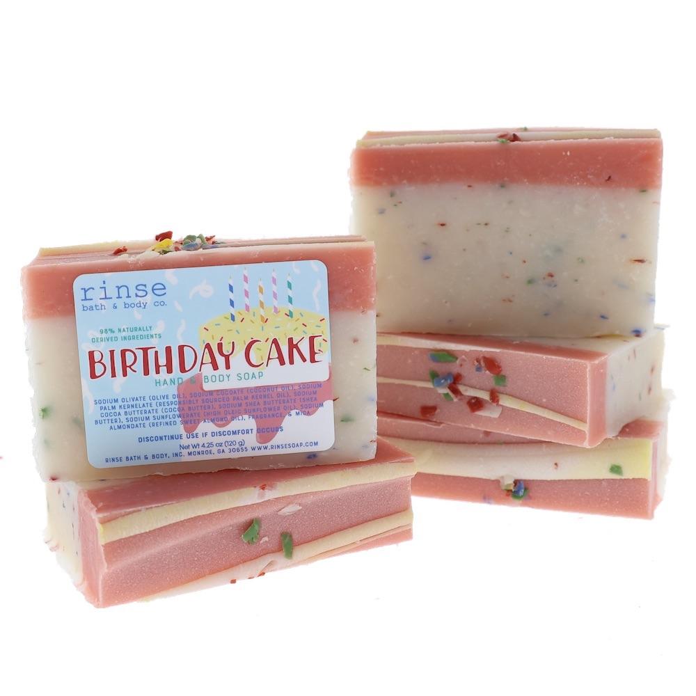 Four Birthday Cake bars stack showing pink tops and confetti — cream layers crisp on bright white
