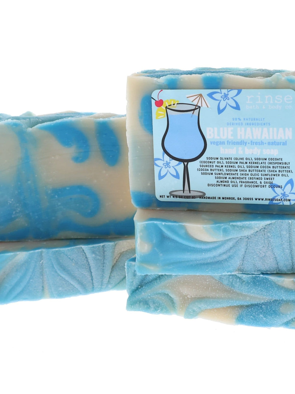 Stacked Blue Hawaiian soap bars reveal wavy blue swirls — clean bright white studio