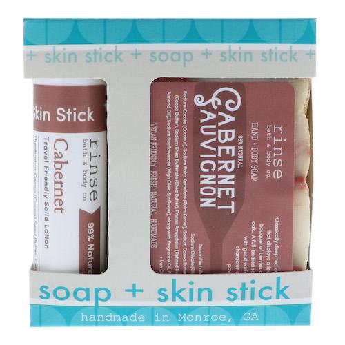 Cabernet soap and Skin Stick sit in a teal-scalloped gift window — burgundy labels on clean bright white