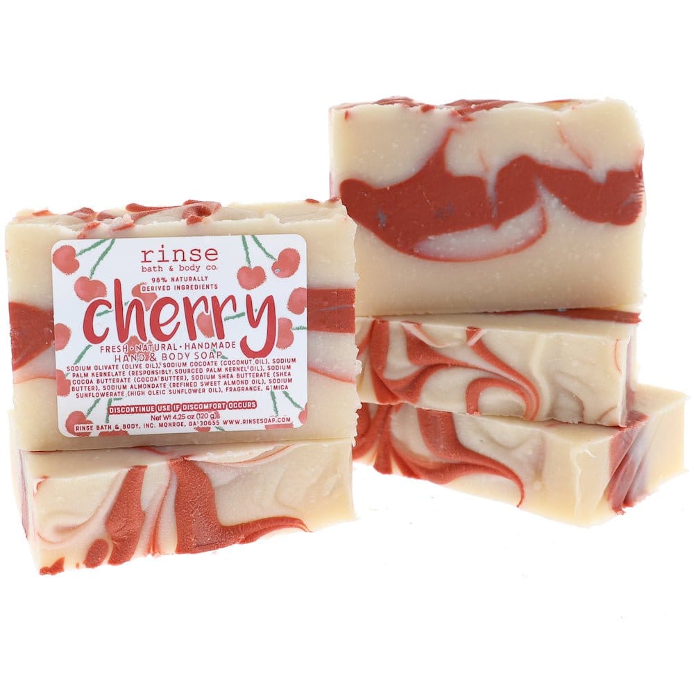 Stacked Cherry bars reveal syrup-red swirls — cream base on stark white studio