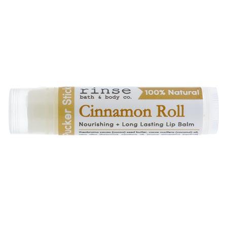 Cinnamon Roll Pucker Stick lies horizontal — brown serif scent name on clean white