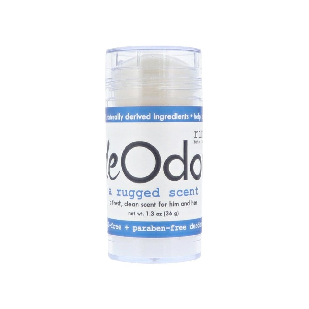 Clear Rugged deOdor tube standing in studio light — creamy aluminum-free balm behind a blue-banded label