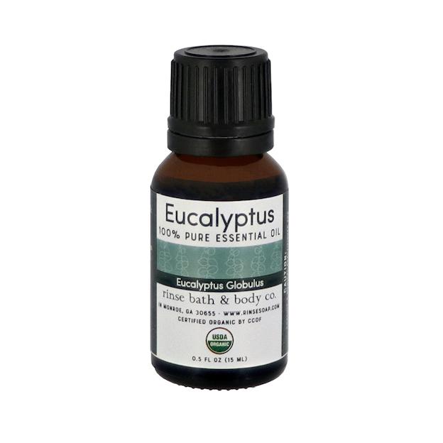 Amber Eucalyptus Globulus essential oil bottle on bright white — black dropper cap and certified organic seal in studio light