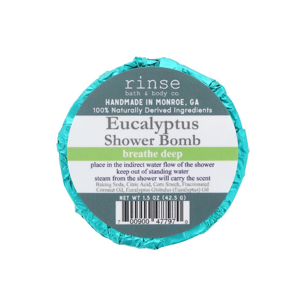 Eucalyptus Shower Bomb wrapped in shiny teal foil on white — breathe-deep banner and eucalyptus oil on the label