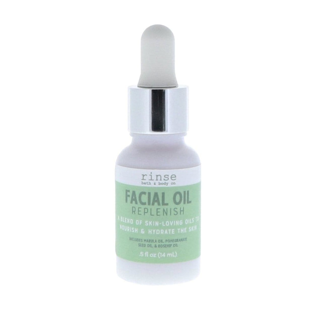 Frosted Facial Oil Replenish bottle standing on bright white — sage label and silver-collar dropper in clean studio light