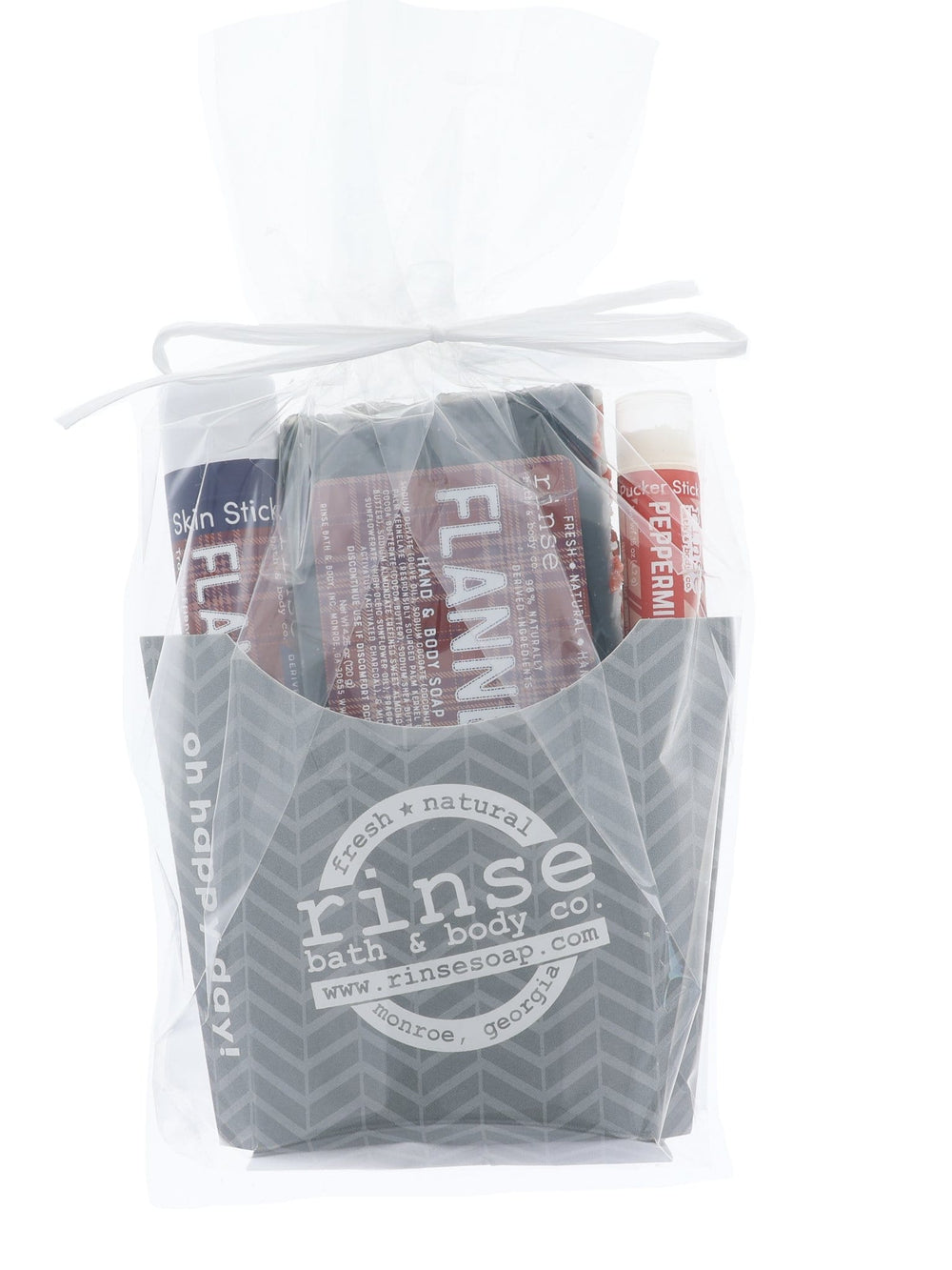 The Flannel fry-box gift set wrapped in clear cellophane and tied with ribbon — arrives gift-ready, no wrapping needed. Rinse Bath & Body Co.