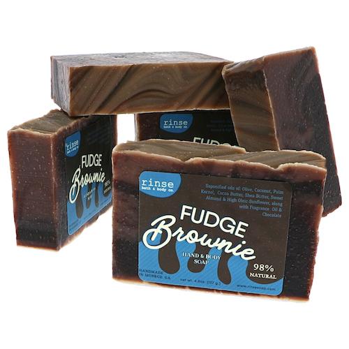 Five brownie-style soap bars lean together — dark cocoa slabs and creamy swirled tops on bright white