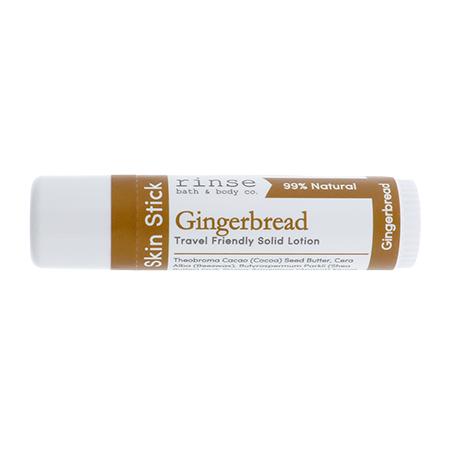Gingerbread Skin Stick lying on bright white — brown label bands and travel tube in clean studio light