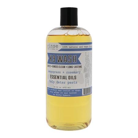 K9 Wash 16 oz bottle standing on bright white — amber lemongrass rosemary soap in clean studio light