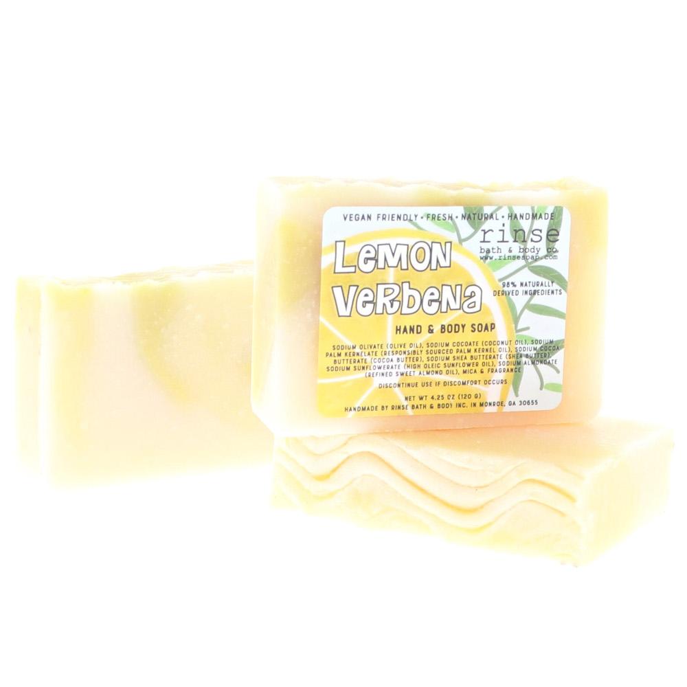 Lemon Verbena bars lean to show wavy scalloped edges — sunny lemon lettering on stark white