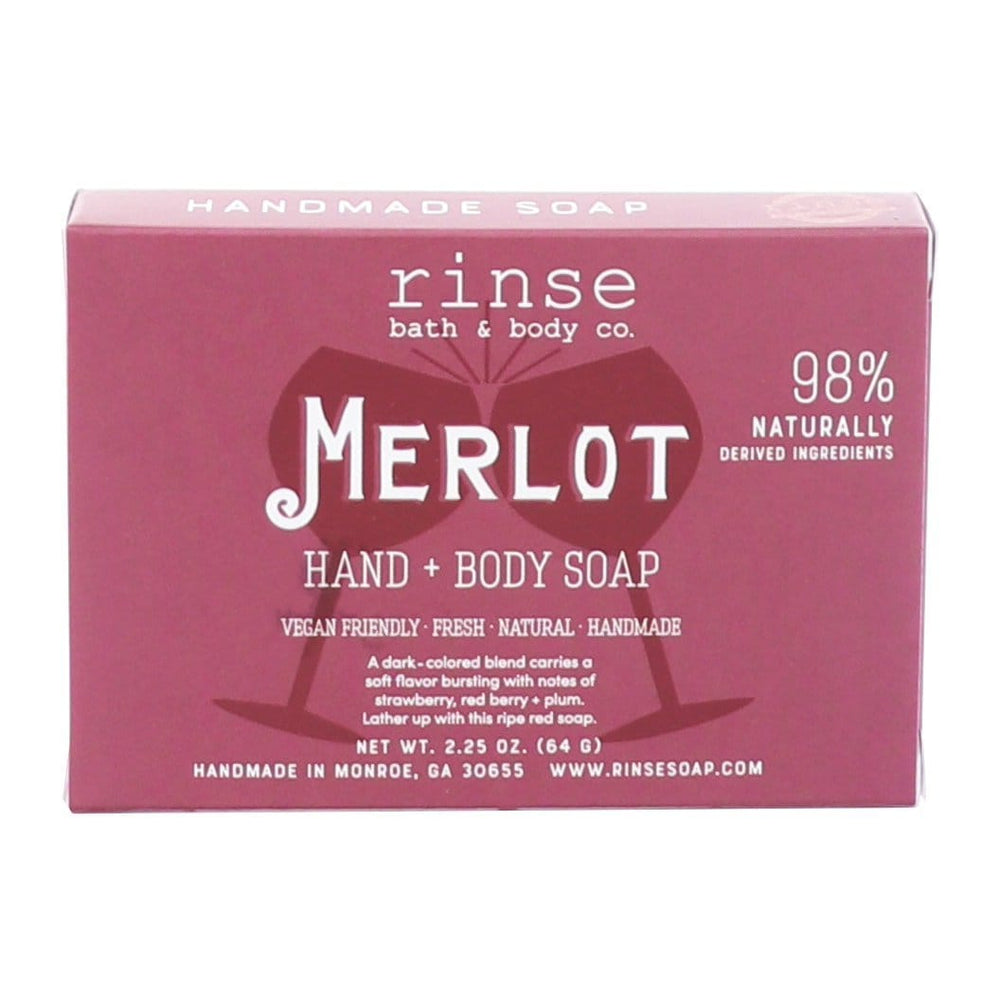 Merlot Hand + Body Soap carton lying horizontal on bright white — deep berry box with wine-glass art