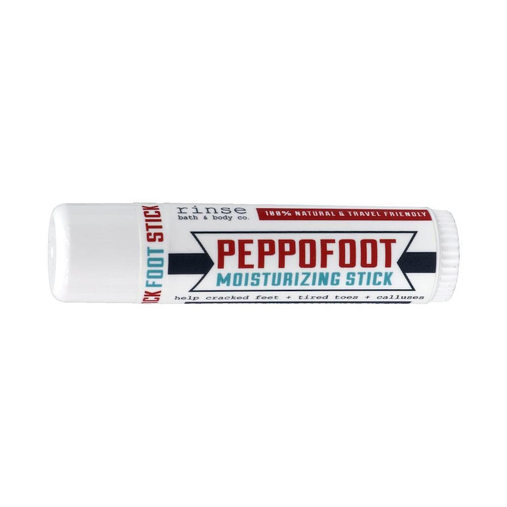 Mini Peppofoot moisturizing stick lying on bright white — red banner label in clean studio light