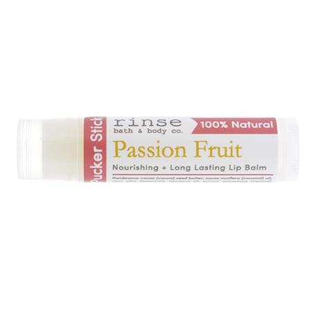 Passion Fruit Pucker Stick lip balm rests horizontally — red gold label on clean bright white