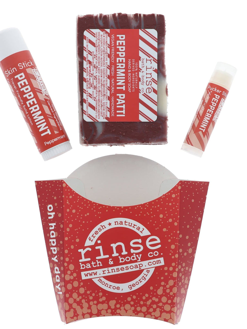 Peppermint Patti laid flat — bar soap, solid lotion Skin Stick, and Pucker Stick above the red dotted fry carton