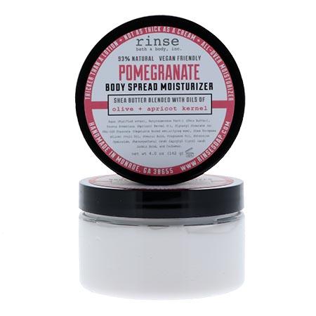 Pomegranate Body Spread jar with lid propped on bright white — thick white cream in a clear jar