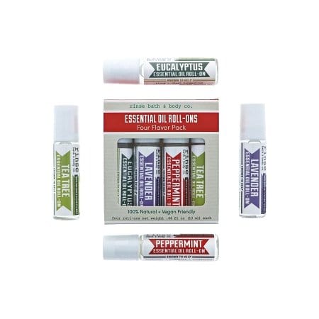 Four Flavor Pack box ringed by Eucalyptus Tea Tree Peppermint and Lavender roll-ons — bright white geometric lay