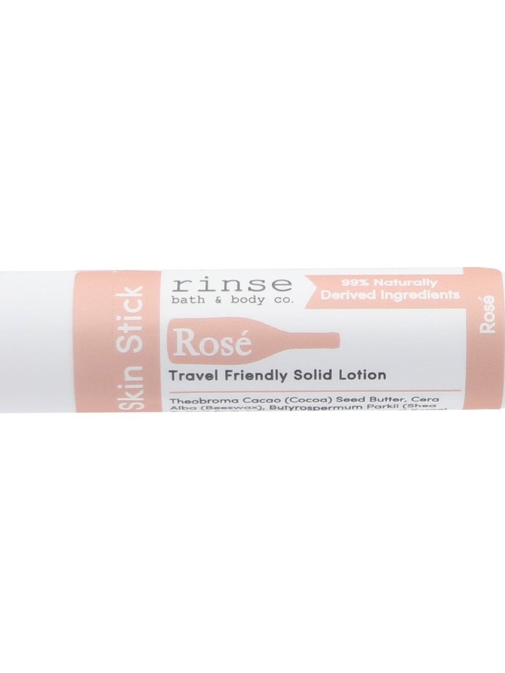 Rosé Skin Stick lying on bright white — soft pink label with wine-bottle silhouette in clean studio light