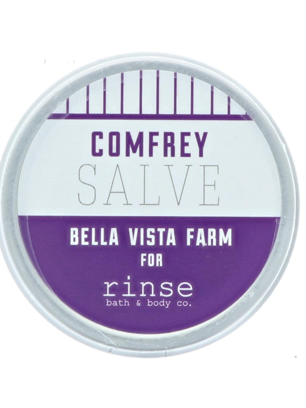 Comfrey Salve tin lid close-up — purple band and pinstripes on stark white