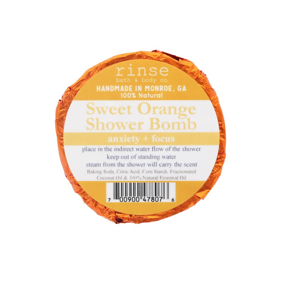 Single Sweet Orange Shower Bomb in orange foil — circular white label on stark white